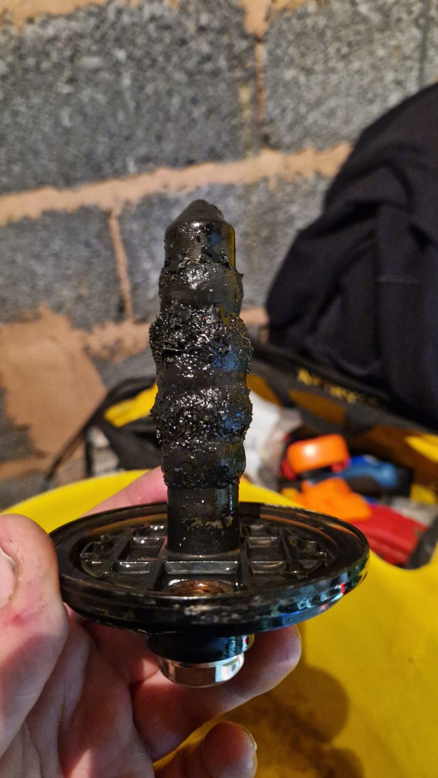 Magnetic filter insert coated in black sludge removed from a heating system