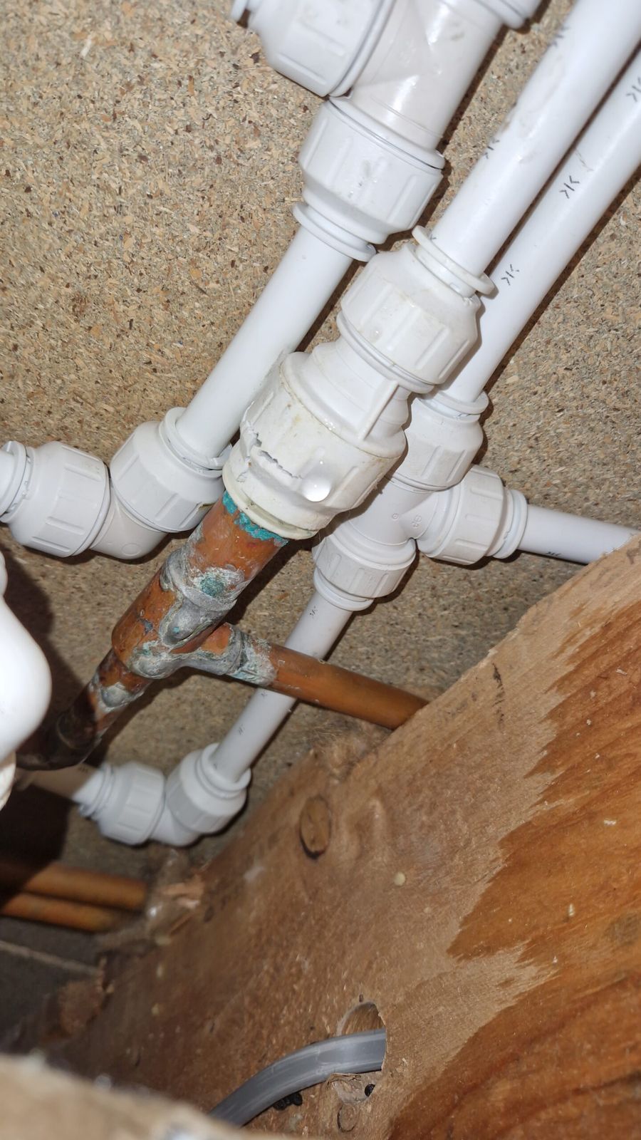 Plastic push-fit pipework joined to older copper pipe under a floor