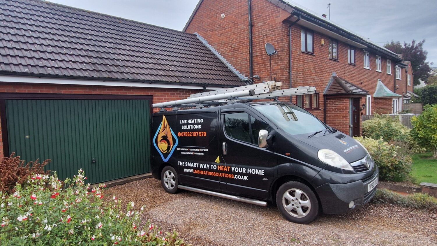 LMS Heating Solutions van with ladders on the roof, parked on a driveway